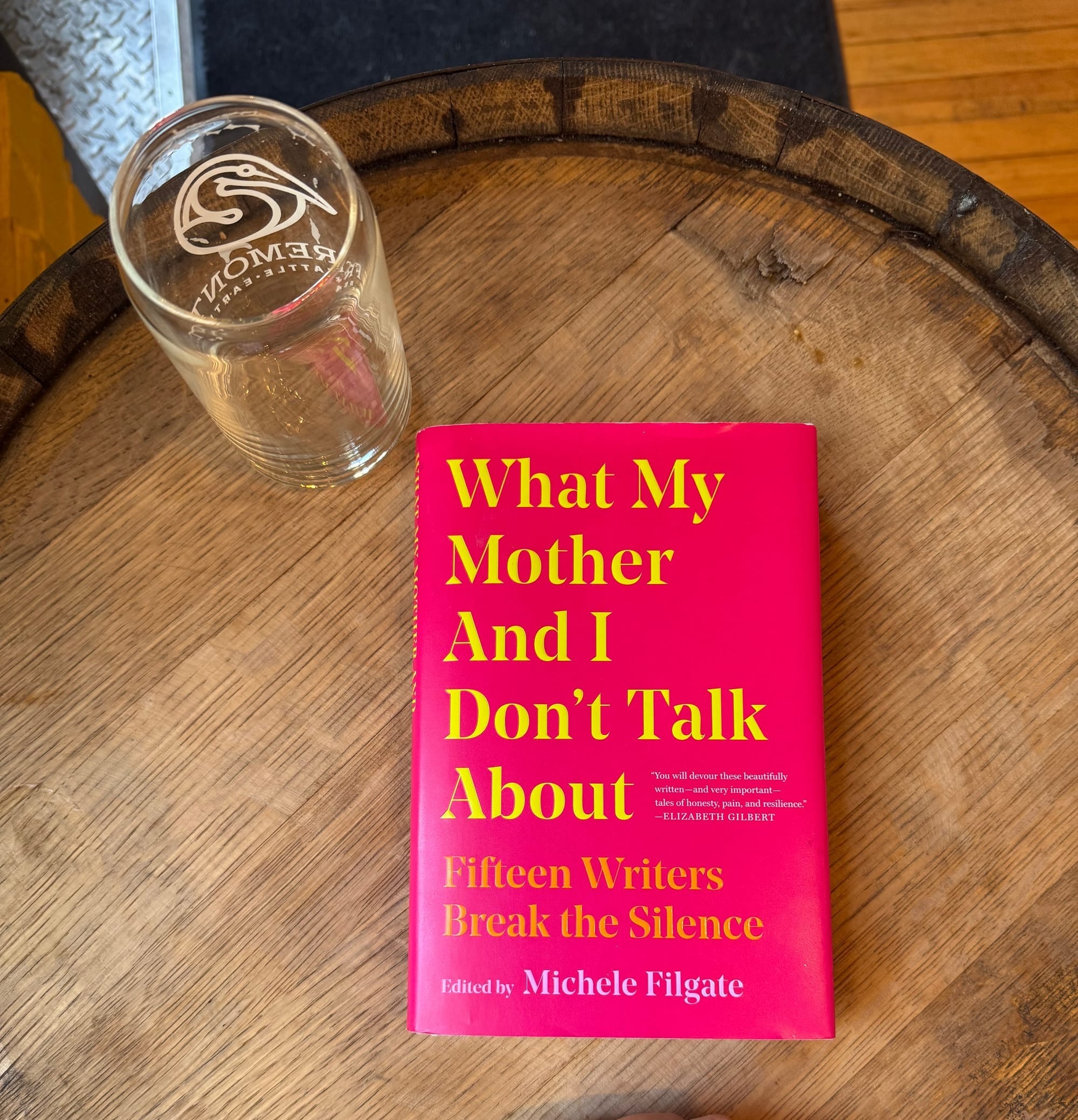 a copy of the book what my mother and I don't talk about and an empty beer glass