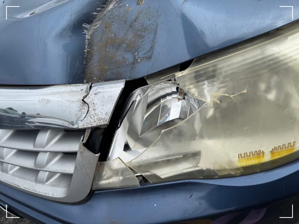 broken headlight and hood on a subaru forester